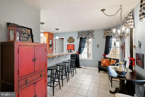 a living room filled with furniture and a chandelier