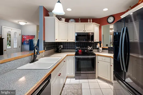 a kitchen with a sink stainless steel appliances and cabinets