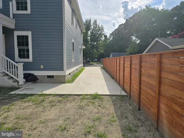 a bathroom with a granite countertop sink and a bathtub