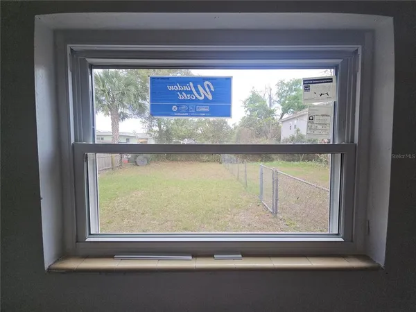 a view of a wooden door and a window