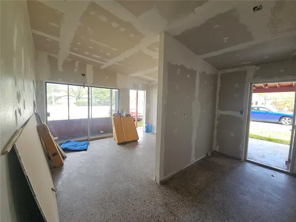 a bedroom with furniture and a large window