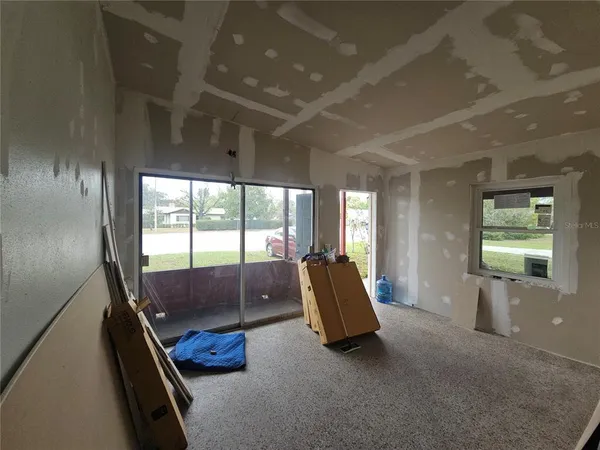 a living room with furniture and a balcony