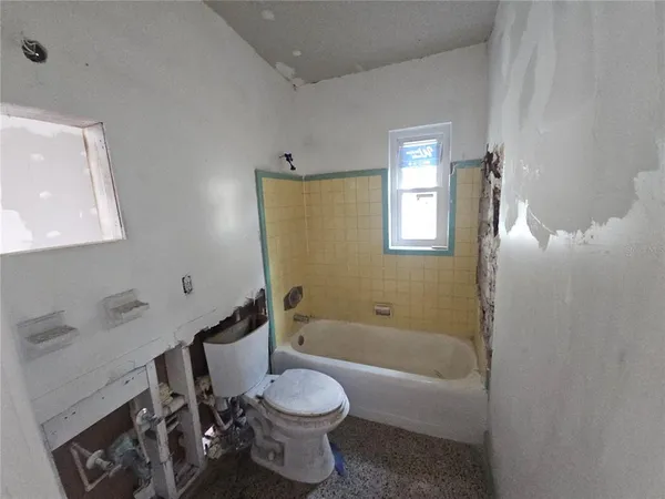 a bathroom with a toilet a sink and bathtub