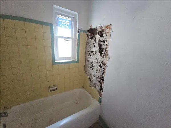 a bathroom with a bathtub and shower