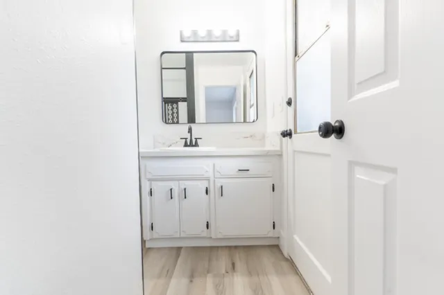 a bathroom with a sink a toilet and mirror