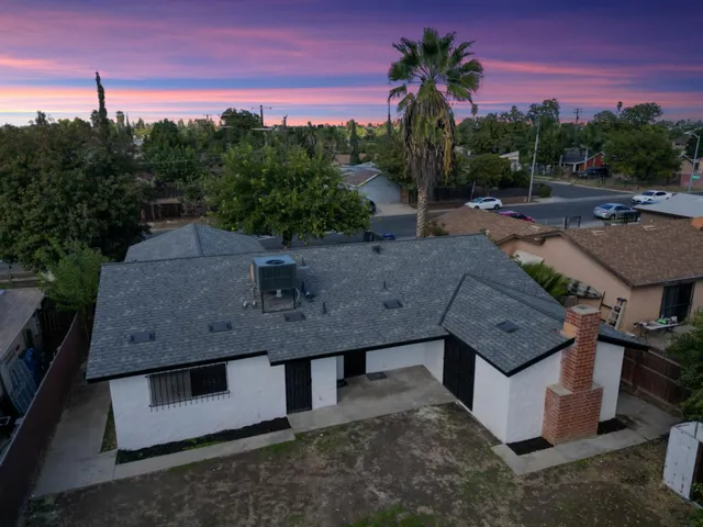 an aerial view of a house with a yard