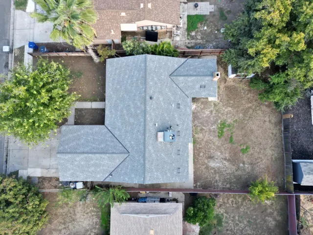 an aerial view of a house with a yard