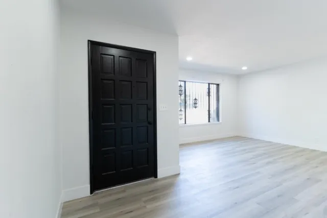 an empty room with wooden floor and closet
