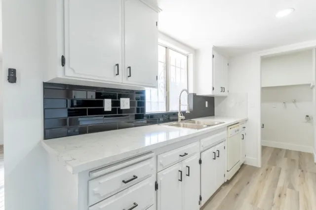 a kitchen with sink and cabinets