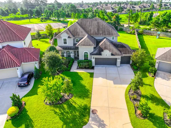 a aerial view of a house with swimming pool garden and patio