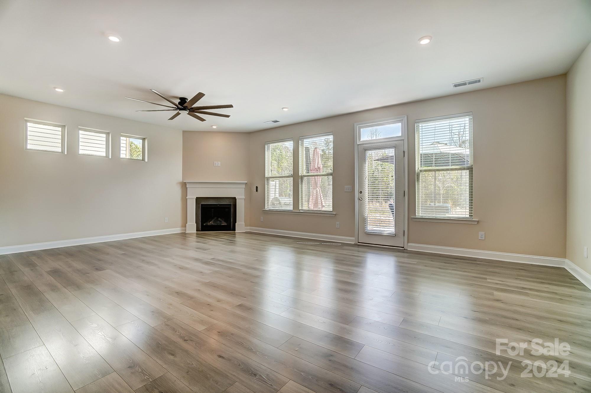 2059 Suttonview Road Fort Mill, SC 29708 - Photo 11 of 44 a view of an empty room with a window and wooden floor