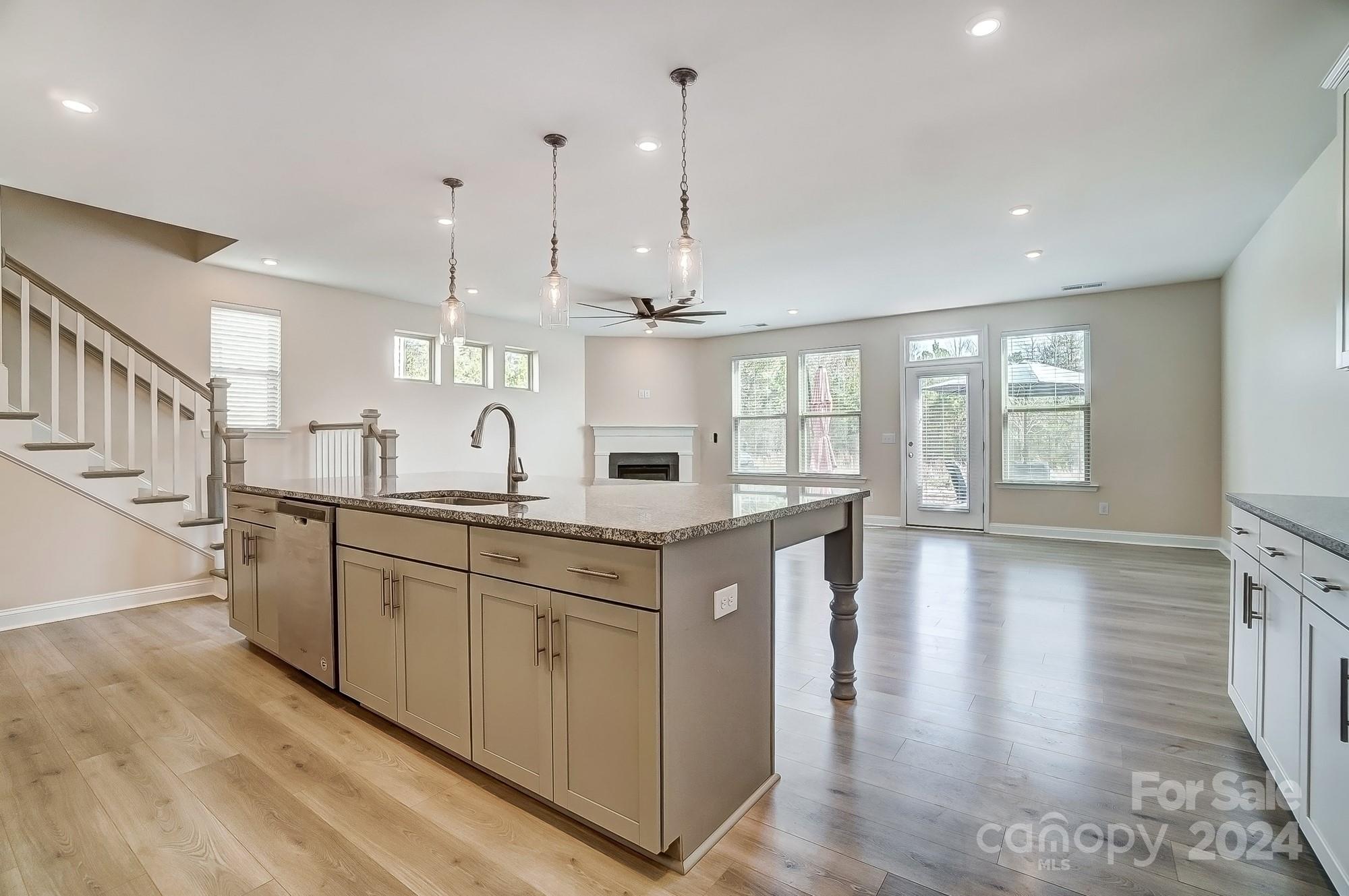 2059 Suttonview Road Fort Mill, SC 29708 - Photo 19 of 44 a kitchen with stainless steel appliances granite countertop a lot of counter space and wooden floors