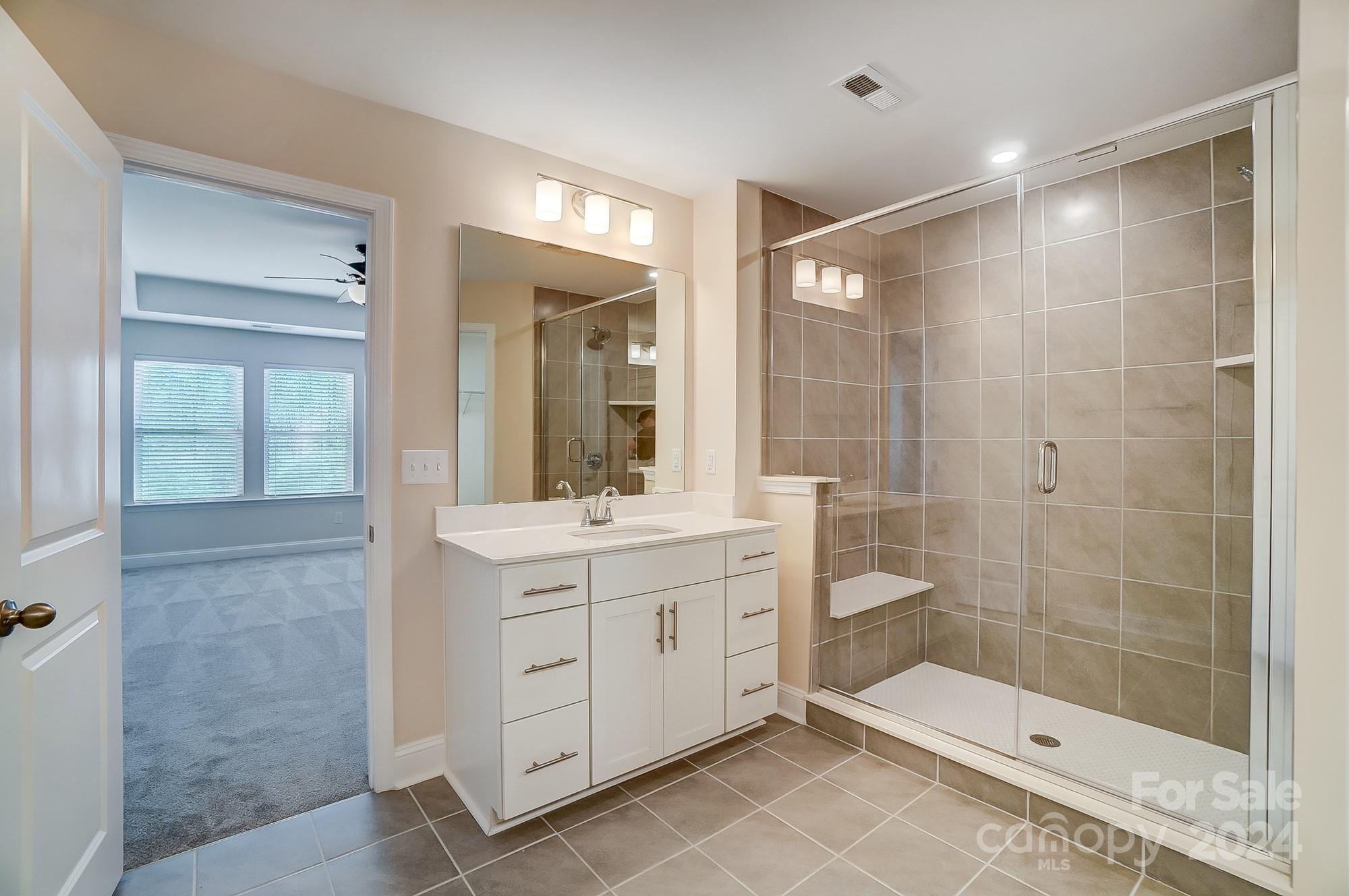 2059 Suttonview Road Fort Mill, SC 29708 - Photo 28 of 44 a bathroom with a shower sink and mirror