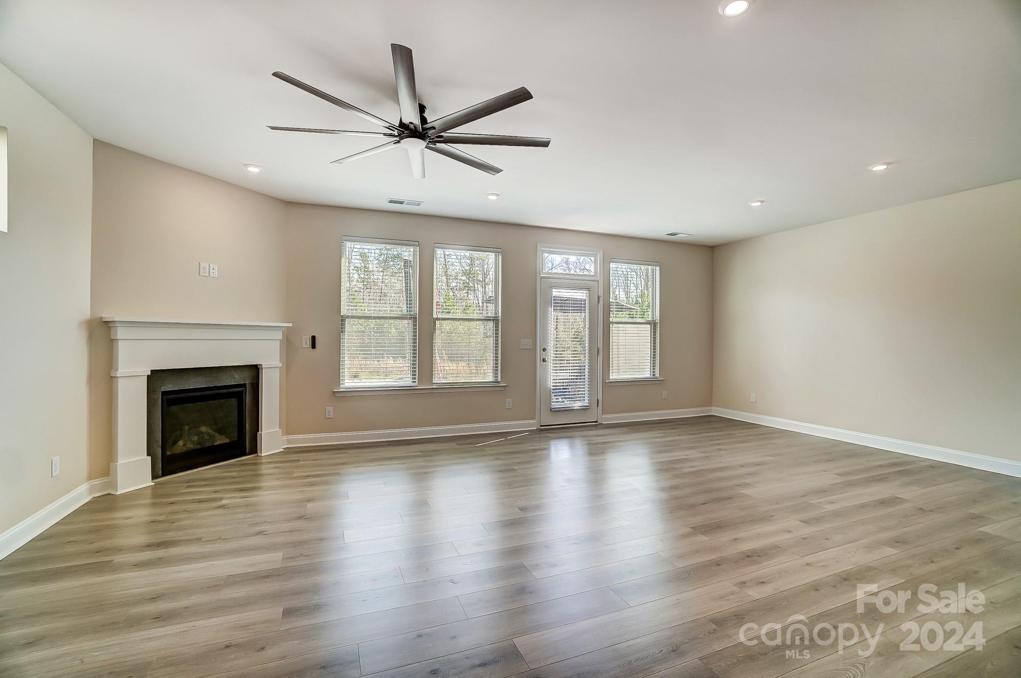 2059 Suttonview Road Fort Mill, SC 29708 - Photo 10 of 44 a view of an empty room with wooden floor and a window
