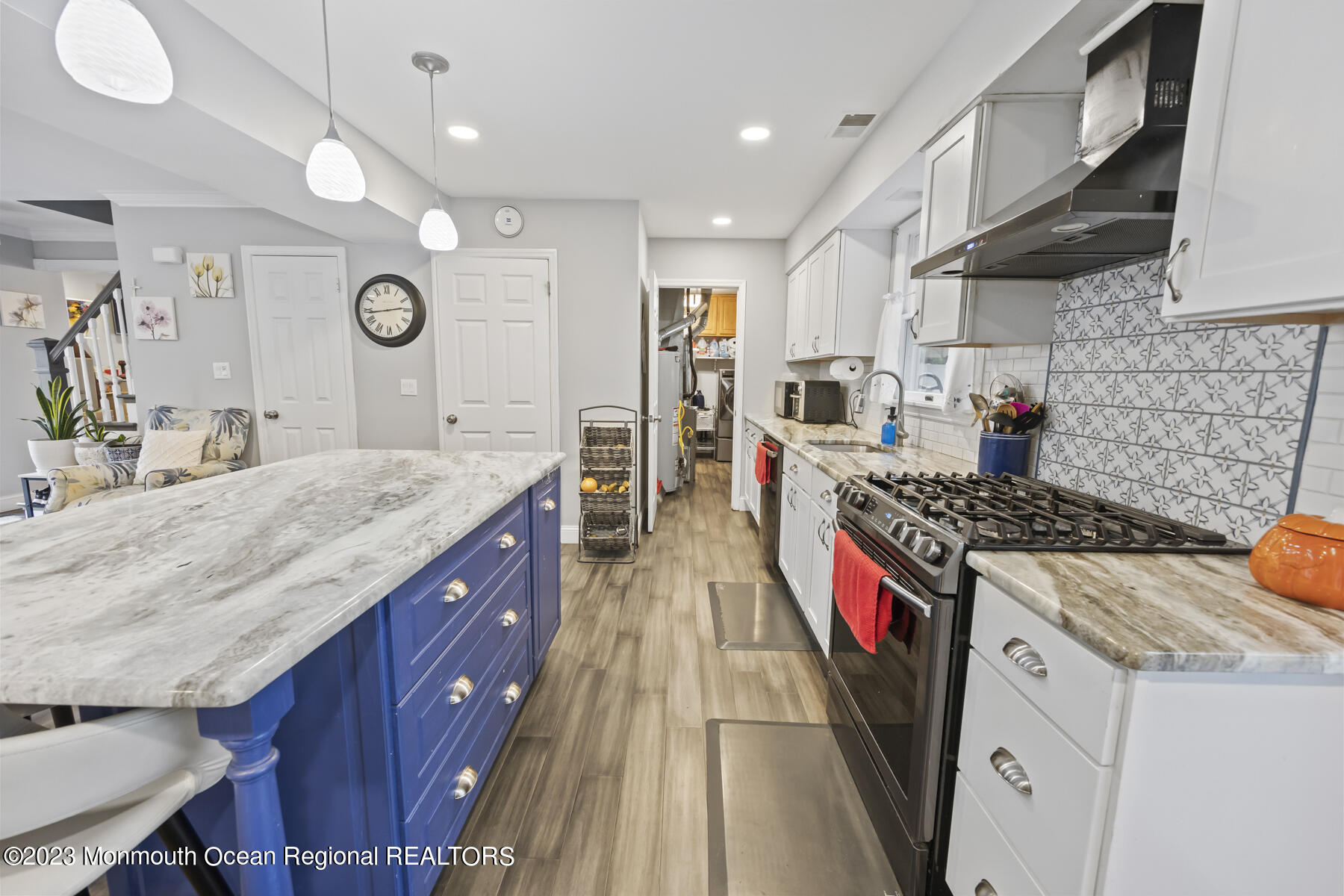 12 Constitution Drive Howell, NJ 07731 - Photo 14 of 39 a kitchen with stainless steel appliances granite countertop a stove a sink dishwasher and cabinets with wooden floor