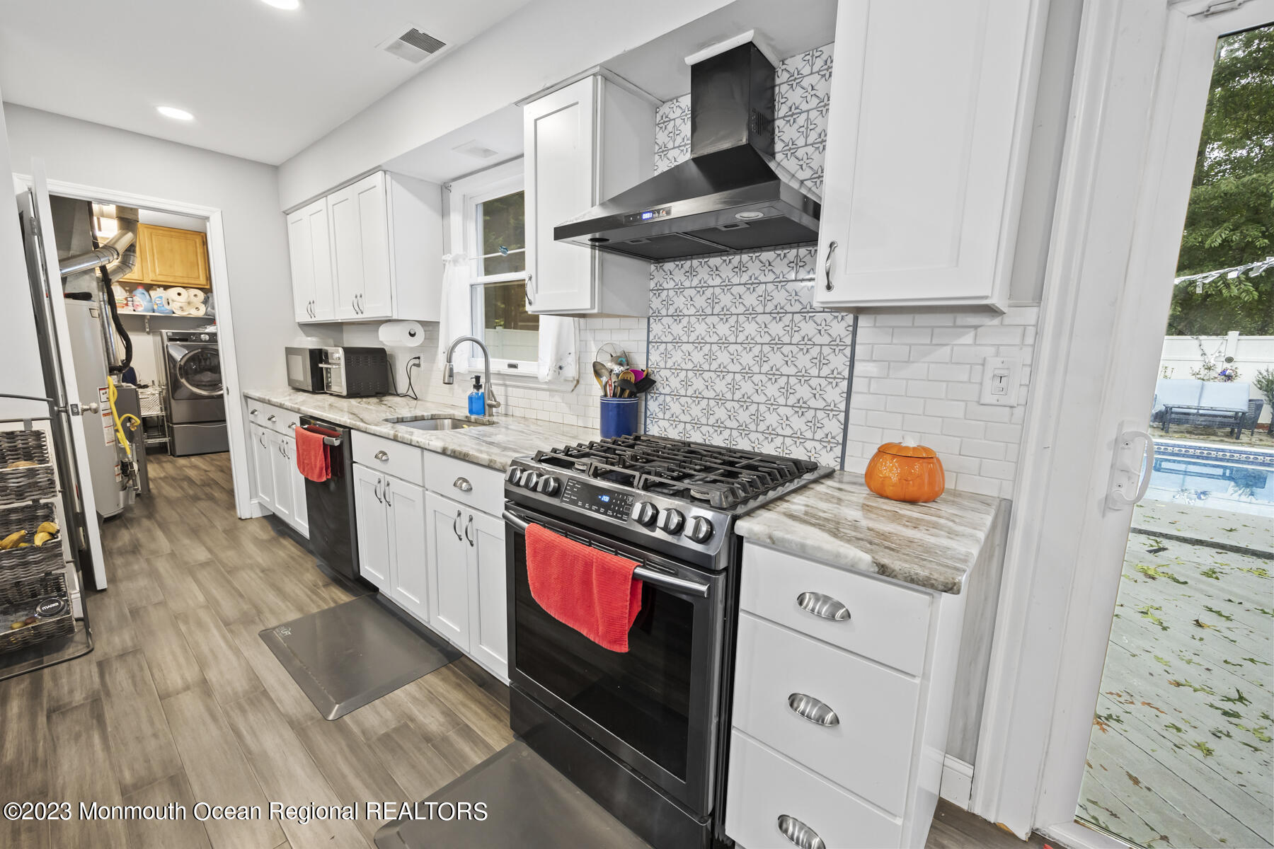 12 Constitution Drive Howell, NJ 07731 - Photo 16 of 39 a kitchen with stainless steel appliances granite countertop a stove and a sink
