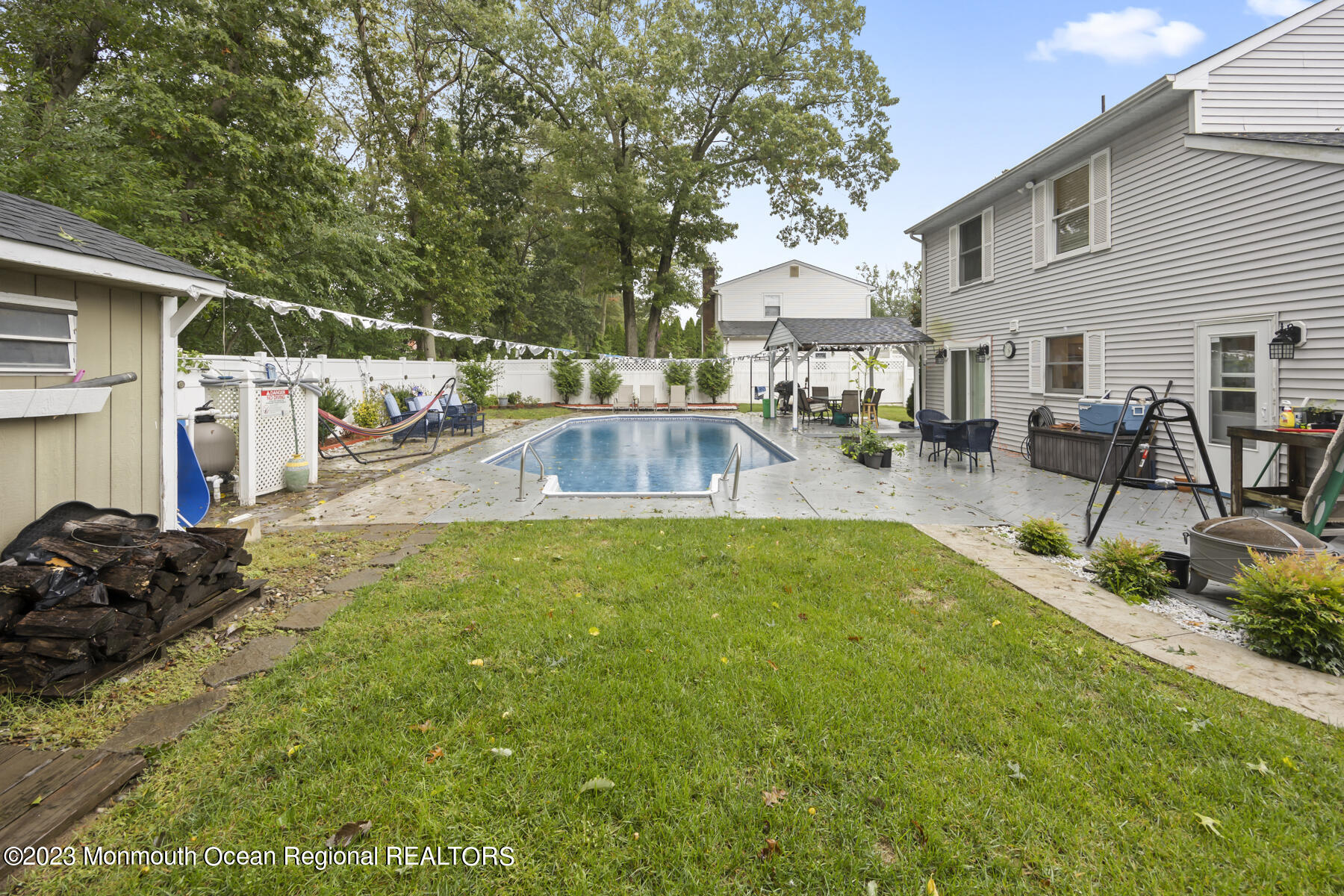 12 Constitution Drive Howell, NJ 07731 - Photo 34 of 39 a view of a patio with table and chairs and potted plants