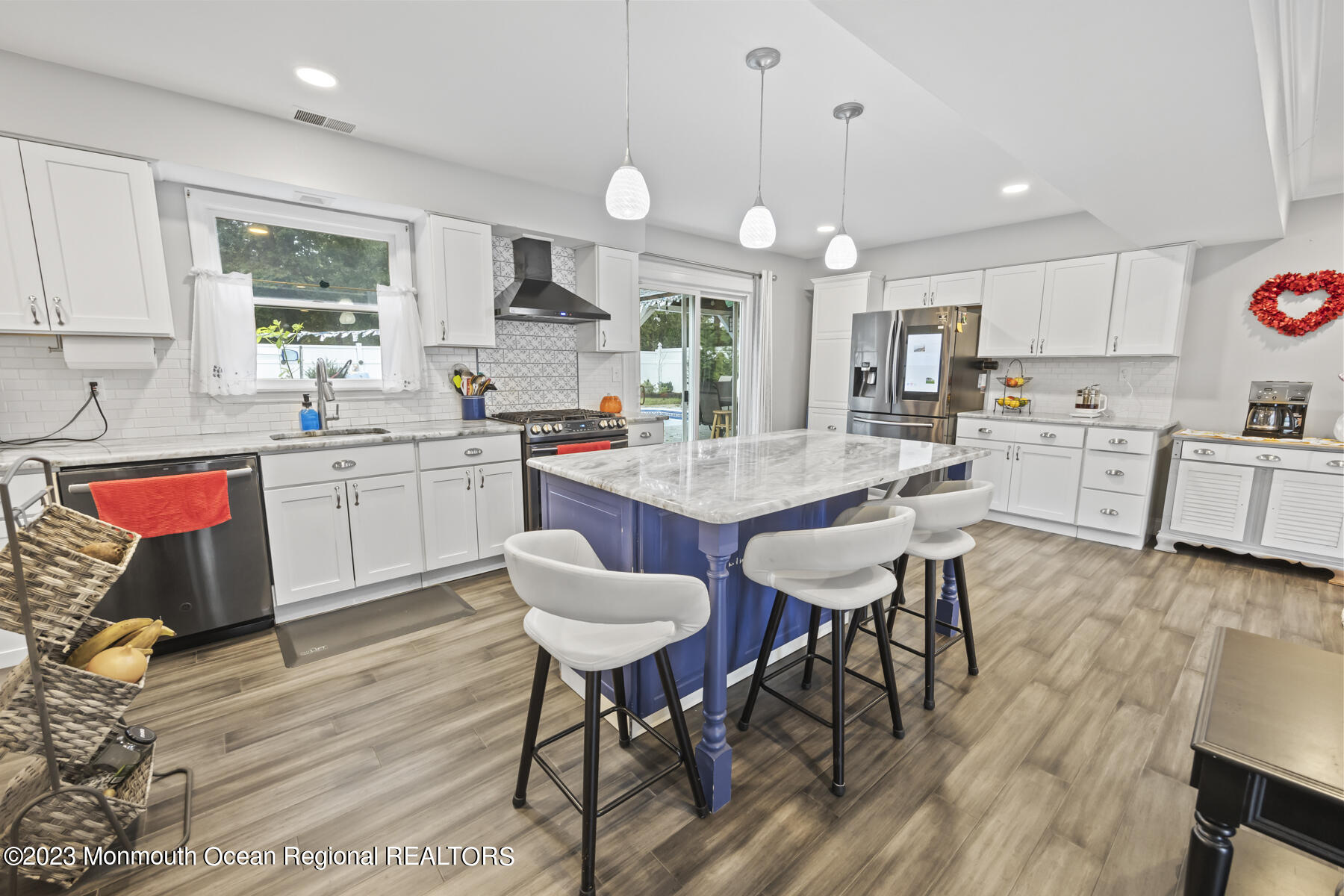 12 Constitution Drive Howell, NJ 07731 - Photo 7 of 39 a kitchen with stainless steel appliances granite countertop a stove a sink a microwave a center island and furniture