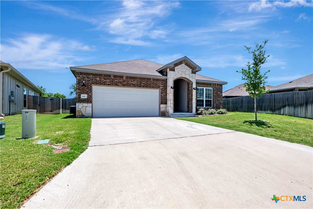 631 Friar Tuck Drive Temple, TX 76502 - Photo 3 of 36 a front view of a house with a yard and garage