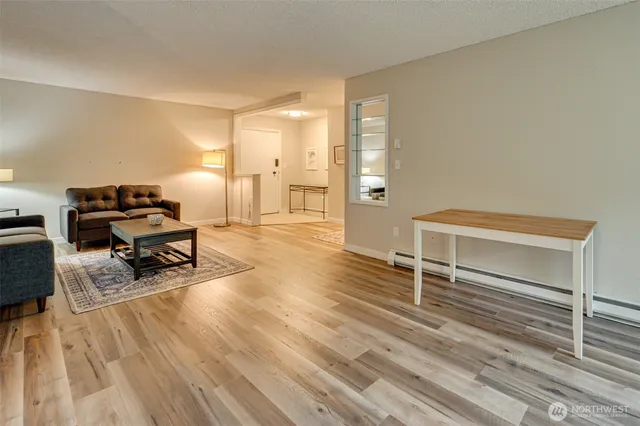 a living room with furniture and a wooden floor