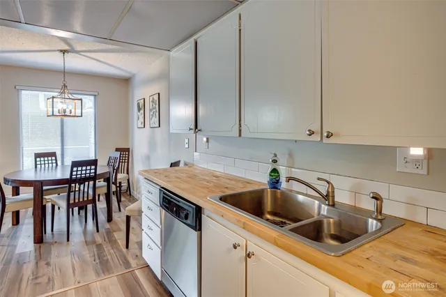 a kitchen with granite countertop a stove a sink and a microwave