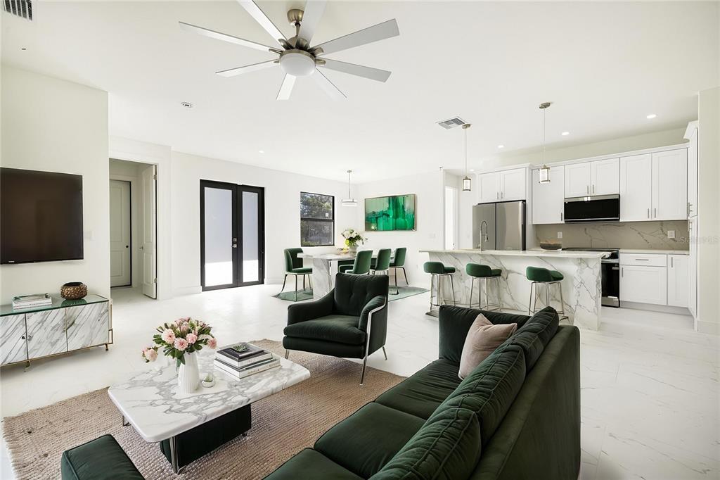 355 Milton Street Port Charlotte, FL 33954 - Photo 11 of 45 a living room with furniture kitchen view and a chandelier