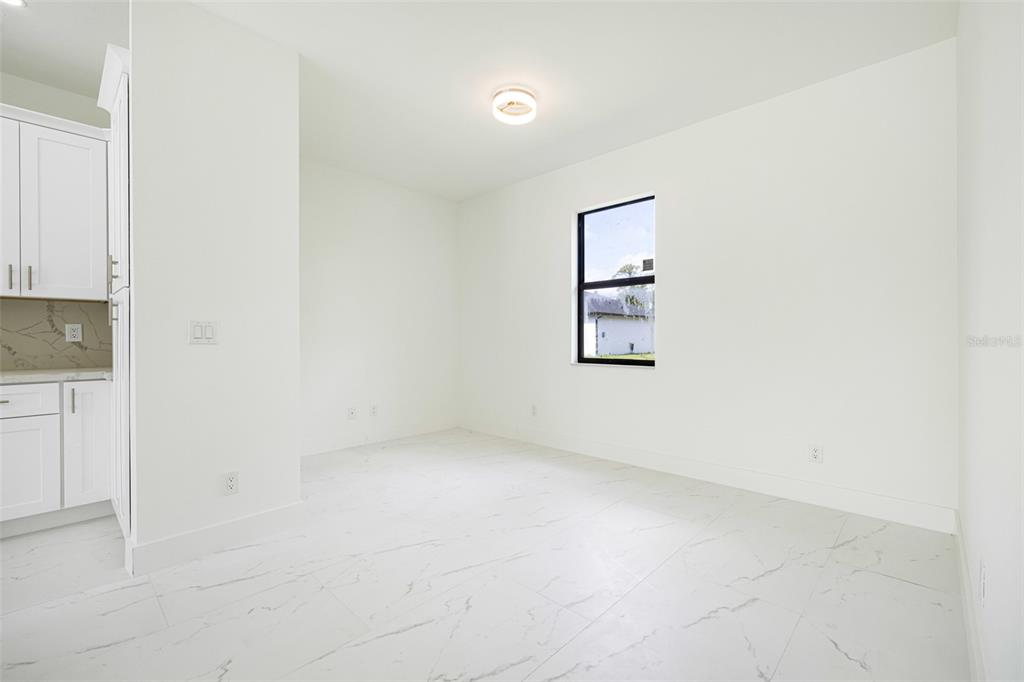 355 Milton Street Port Charlotte, FL 33954 - Photo 13 of 45 an empty room with a workbench