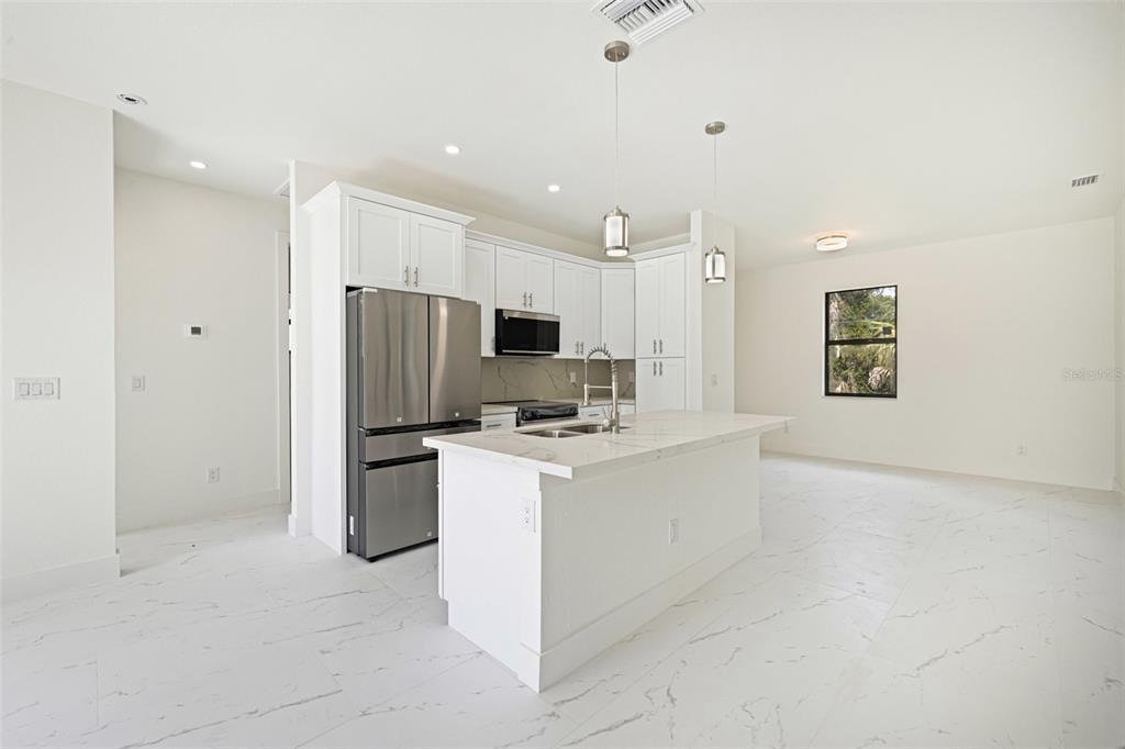 355 Milton Street Port Charlotte, FL 33954 - Photo 17 of 45 a kitchen with refrigerator and cabinets