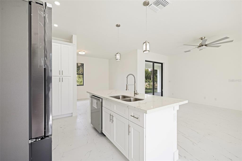 355 Milton Street Port Charlotte, FL 33954 - Photo 18 of 45 a kitchen with a sink stove and refrigerator