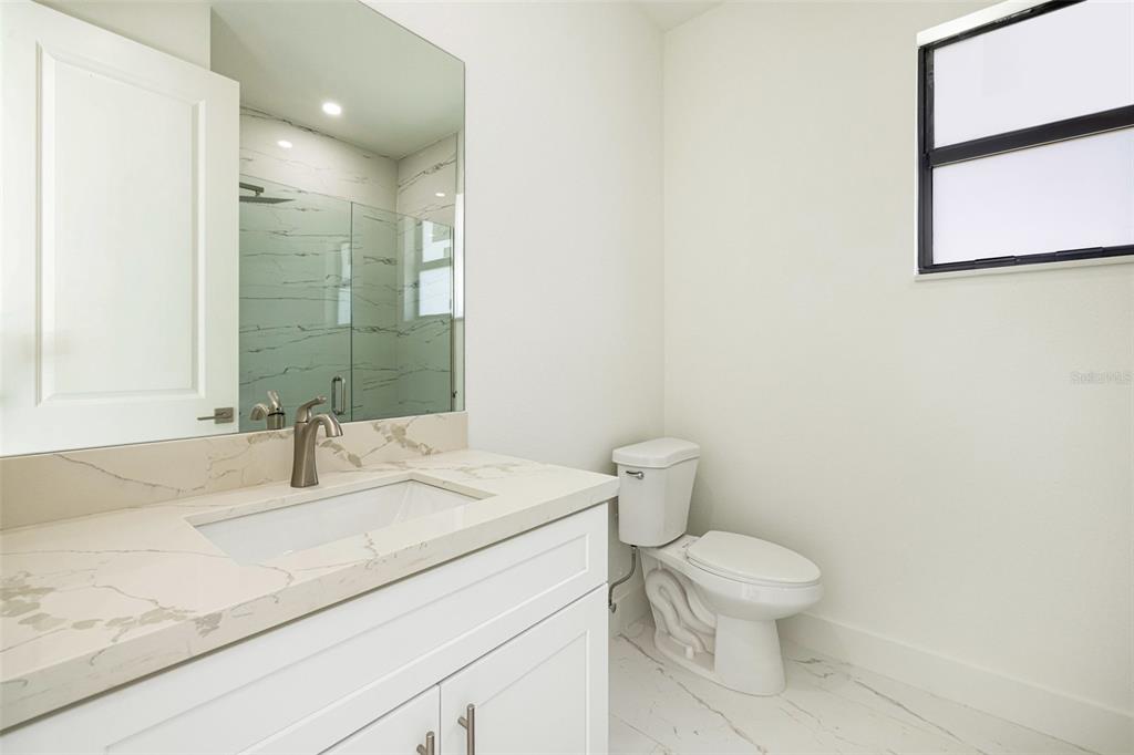 355 Milton Street Port Charlotte, FL 33954 - Photo 25 of 45 a bathroom with a sink toilet vanity and shower