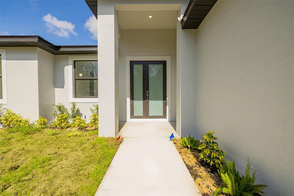 355 Milton Street Port Charlotte, FL 33954 - Photo 3 of 45 a front view of a house with a yard