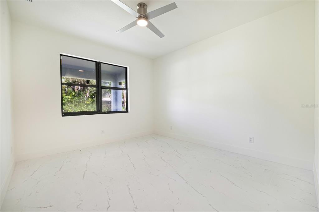 355 Milton Street Port Charlotte, FL 33954 - Photo 32 of 45 an empty room with a window and a ceiling fan