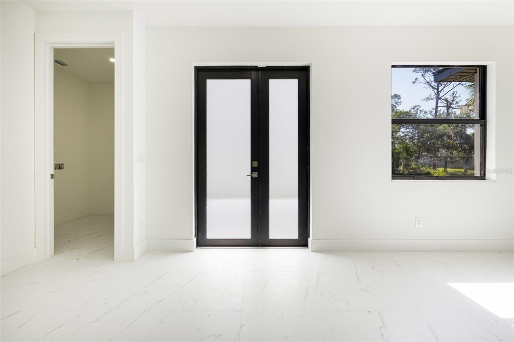 355 Milton Street Port Charlotte, FL 33954 - Photo 4 of 45 an empty room with windows and closet