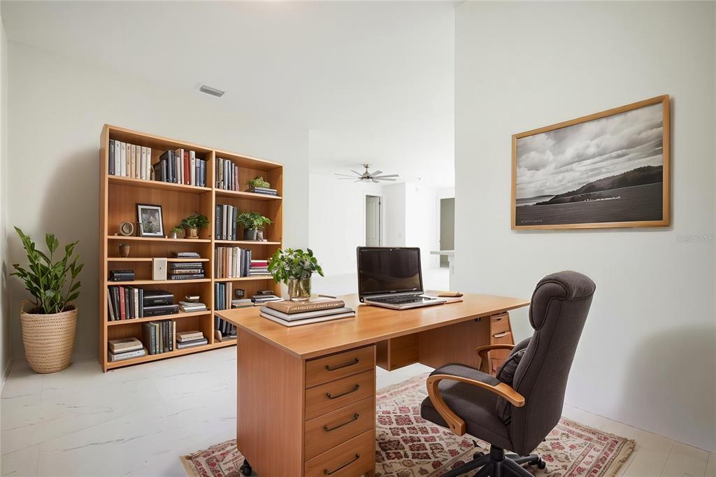 355 Milton Street Port Charlotte, FL 33954 - Photo 9 of 45 a workspace with furniture and book shelf
