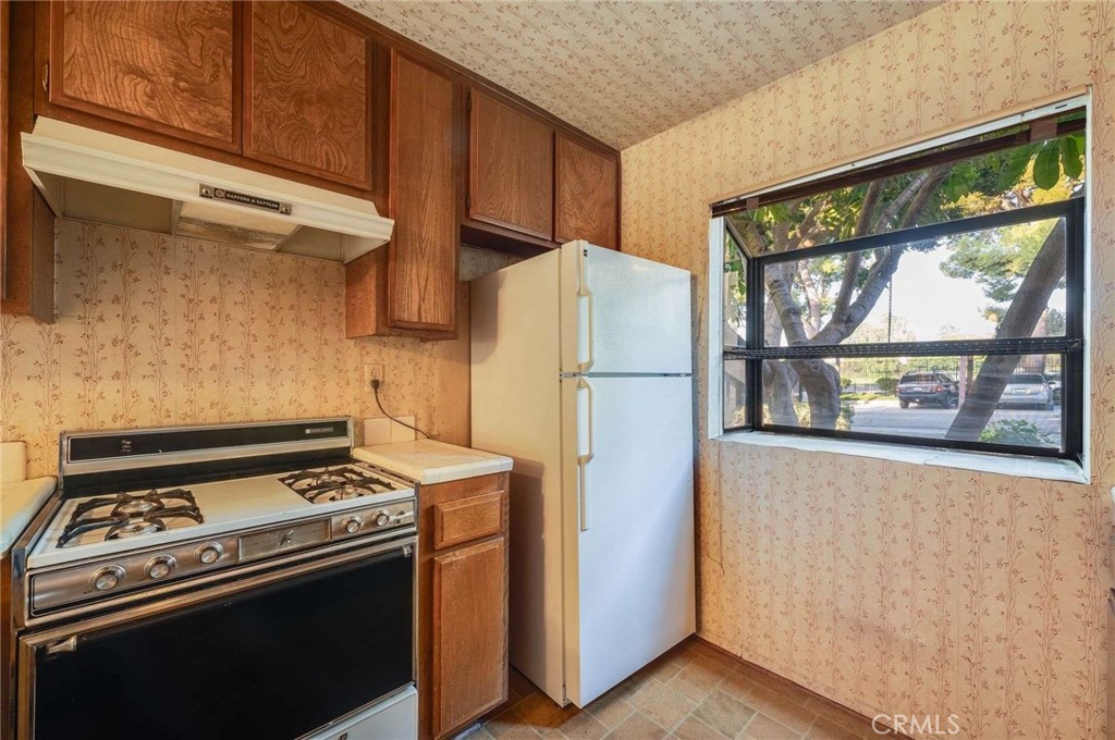 4140 Workman Mill Road, Unit 170 Whittier, CA 90601 - Photo 11 of 32 a kitchen with a stove and a refrigerator