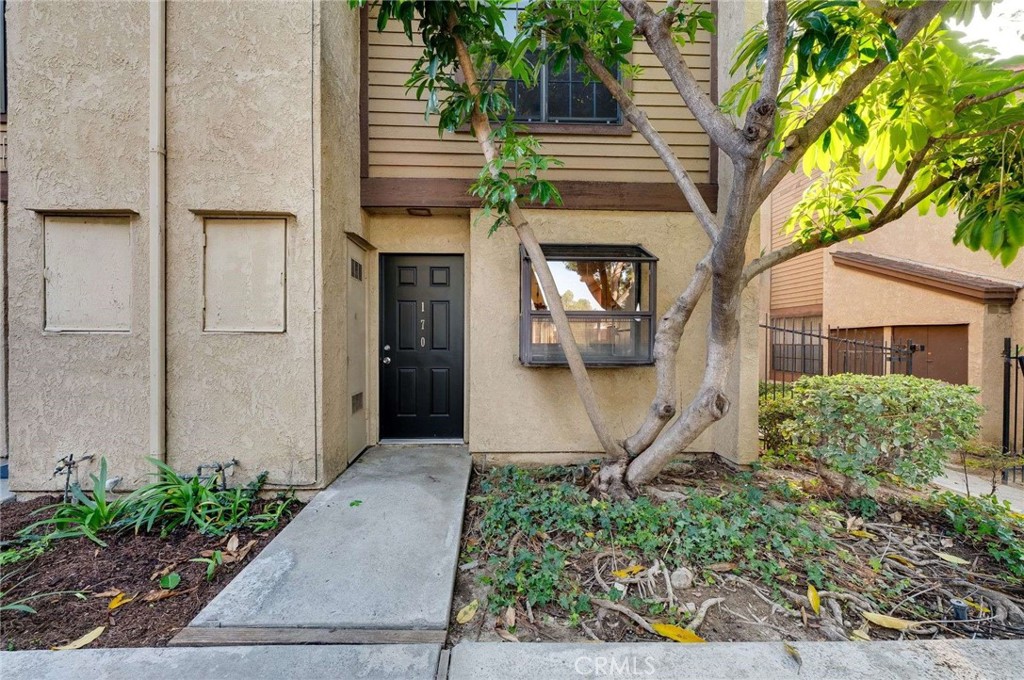4140 Workman Mill Road, Unit 170 Whittier, CA 90601 - Photo 2 of 32 a front view of a house with a yard