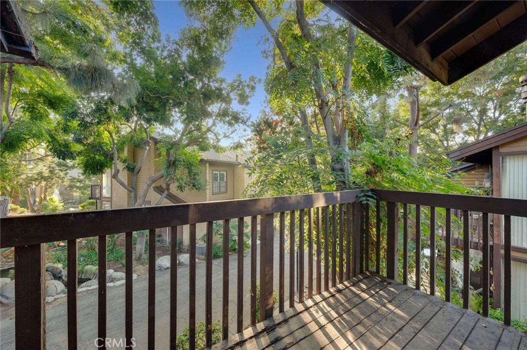 4140 Workman Mill Road, Unit 170 Whittier, CA 90601 - Photo 22 of 32 a balcony with wooden floor and outdoor space