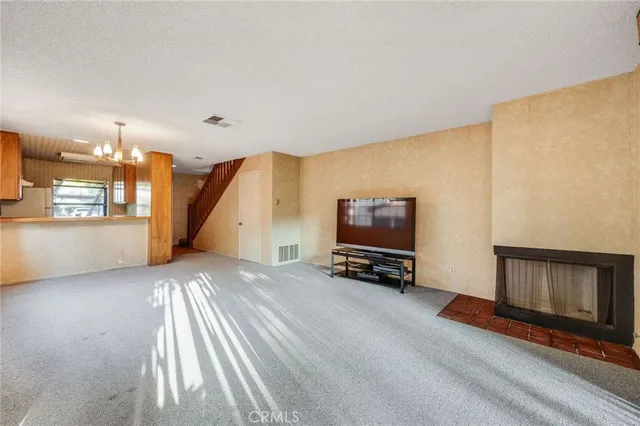 a view of a livingroom with furniture and a flat screen tv