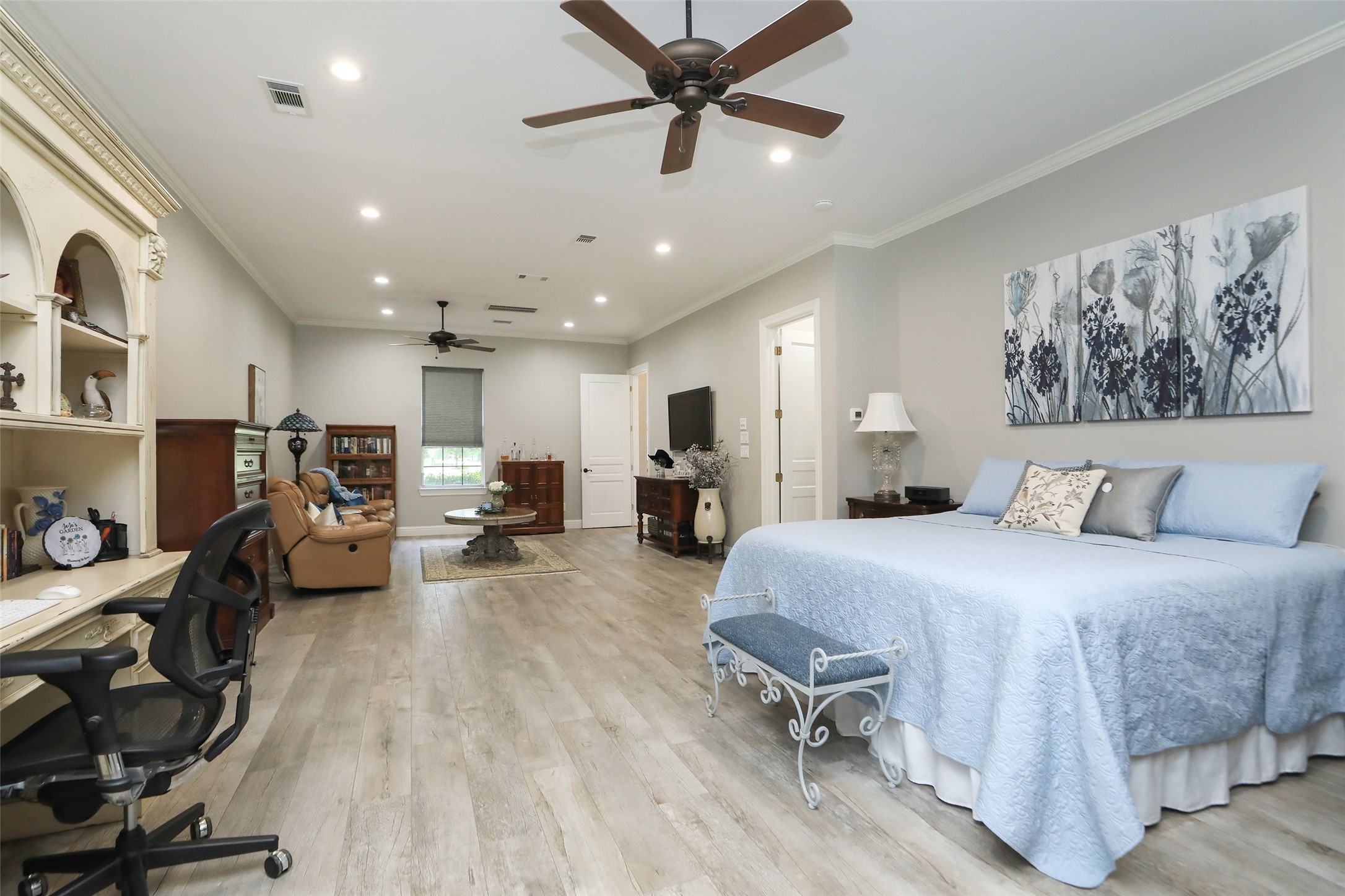 12126 Zion Road Tomball, TX 77375 - Photo 22 of 45 Primary bedroom with en-suite bathroom, wood look tile floors, crown molding, ceiling fans and large sitting area.
