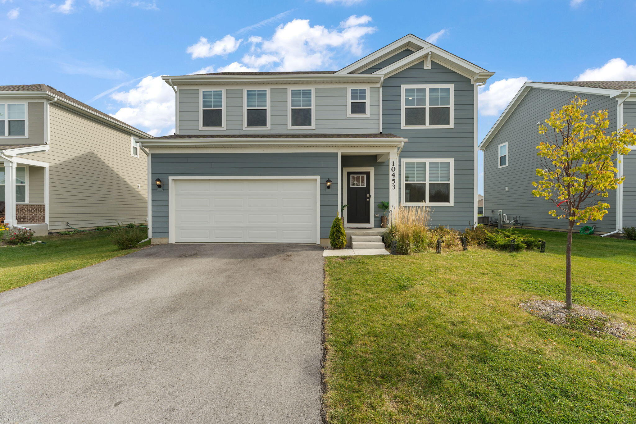 10453 Privet Drive Crown Point, IN 46307 - Photo 2 of 38 a front view of a house with a yard and garage