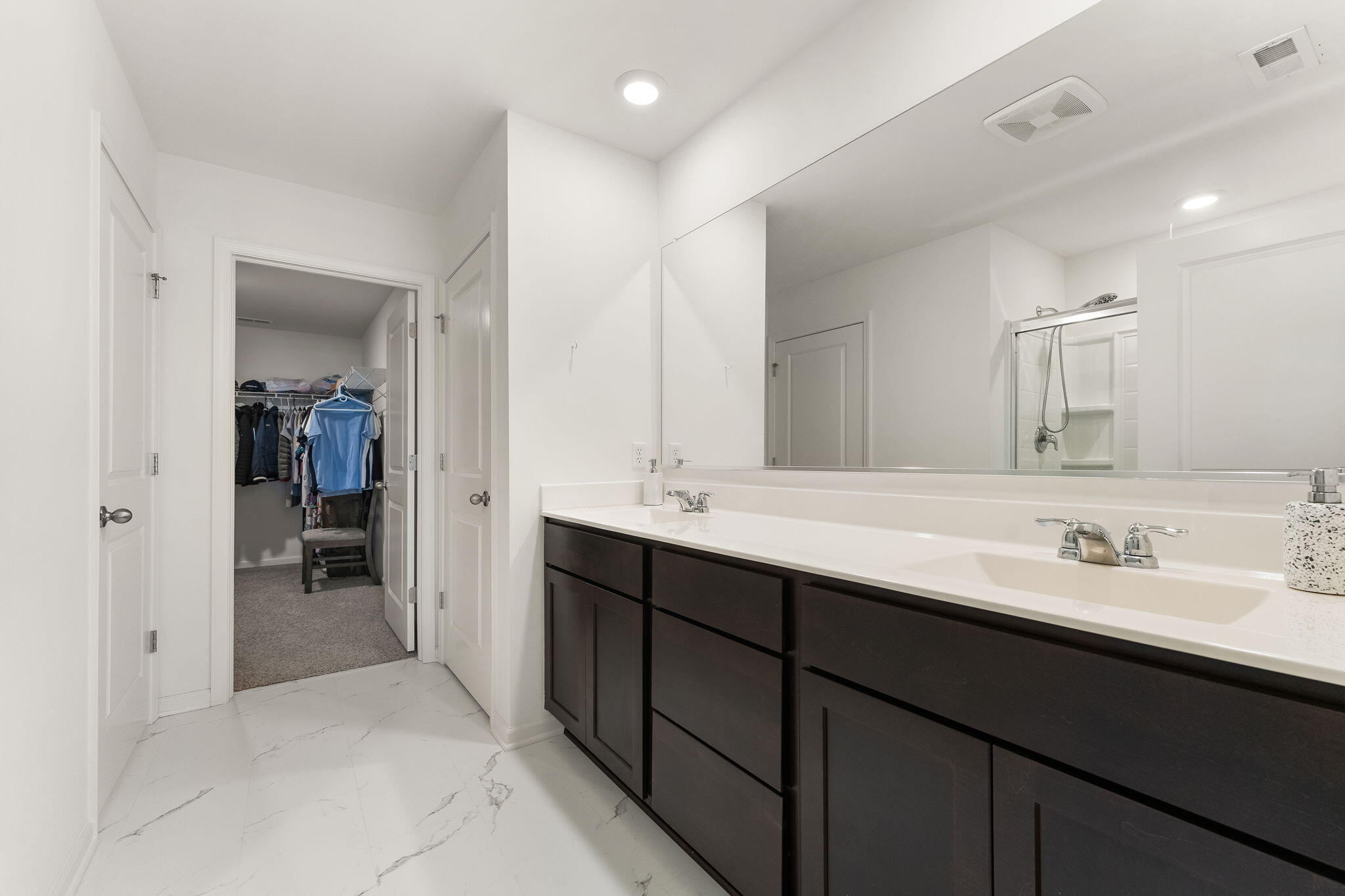 10453 Privet Drive Crown Point, IN 46307 - Photo 23 of 38 a en suite bathroom with a double vanity sink and a mirror