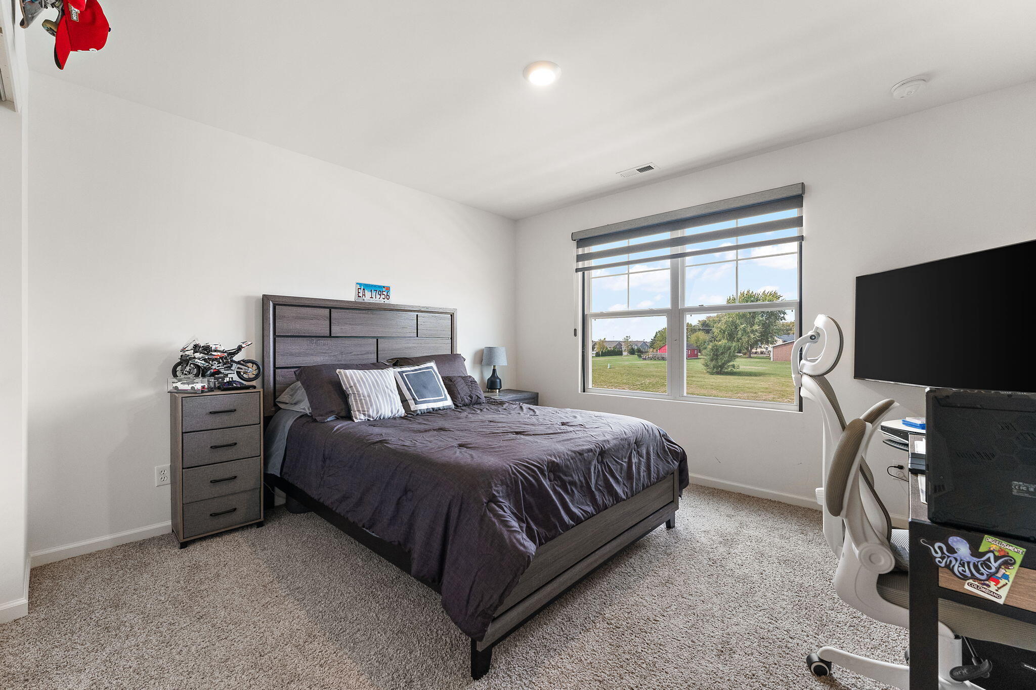 10453 Privet Drive Crown Point, IN 46307 - Photo 24 of 38 a bedroom with a bed and a flat screen tv