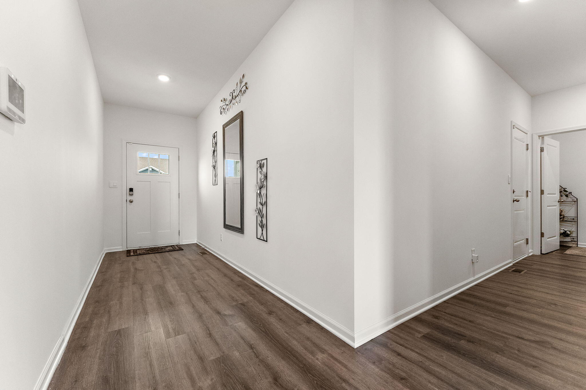 10453 Privet Drive Crown Point, IN 46307 - Photo 7 of 38 a view of a hallway with wooden floor
