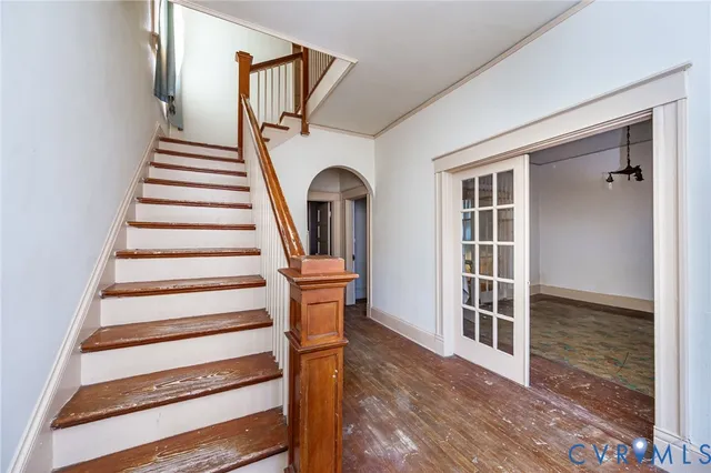 a view of entryway and hall with wooden floor