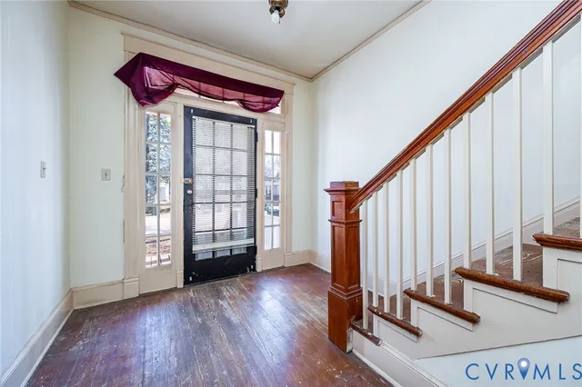 a view of an entryway with wooden floor and door