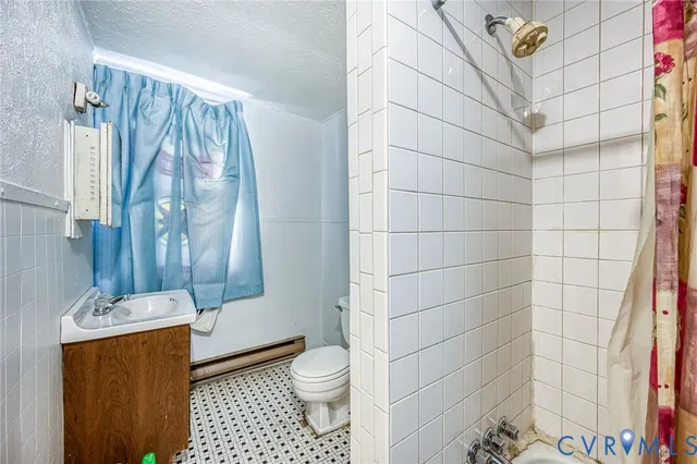 a bathroom with a toilet and shower