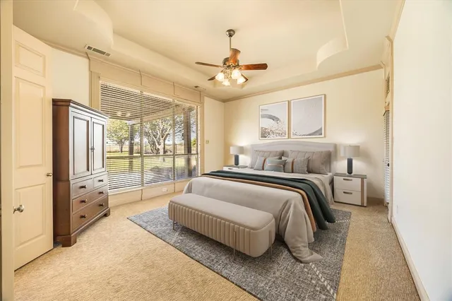 a spacious bedroom with a bed and a large window