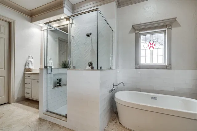 a bathroom with a tub a sink and a mirror