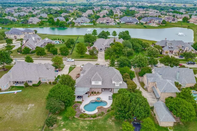 an aerial view of a house with a lake view