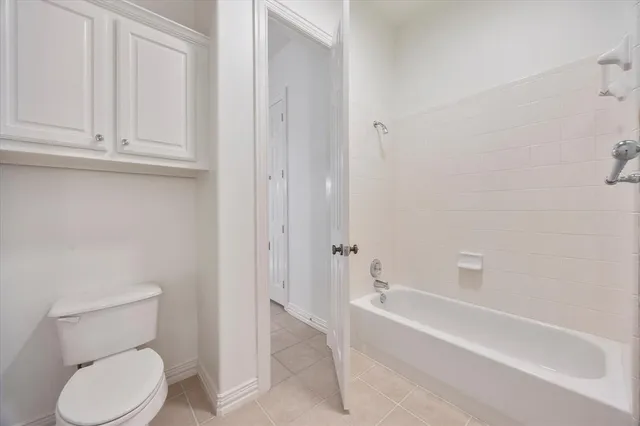 a bathroom with a toilet and bathtub